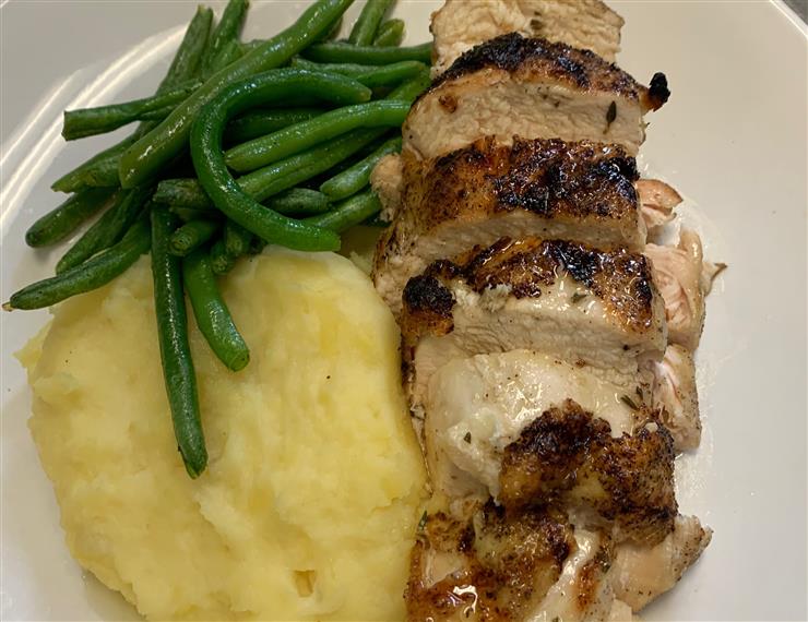Half Roasted Herbed Chicken served with mashed potatoes and green beans